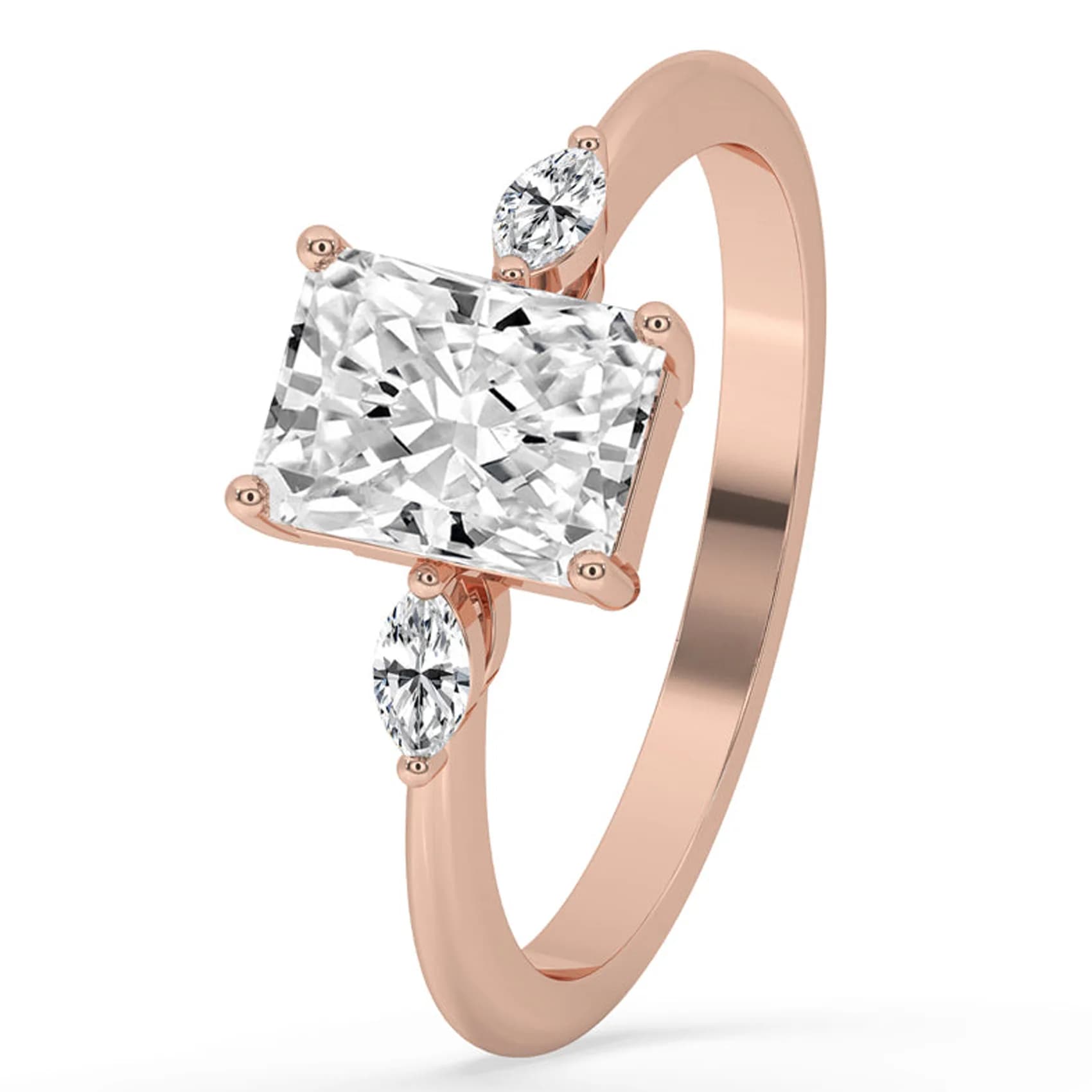 Angled view of the radiant cut three stone ring with marquise sides in rose gold